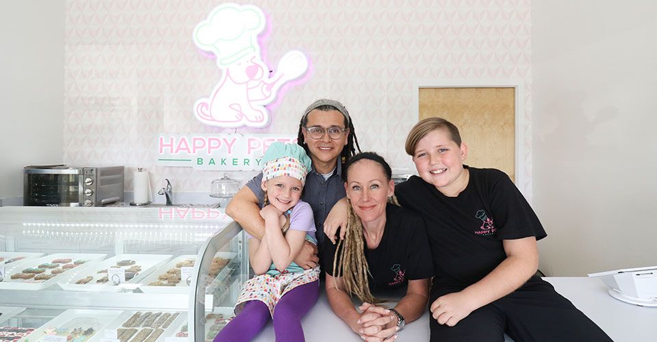 Happy Pets Bakery team smiling in their store
